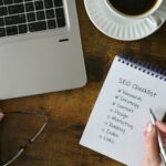 Female checking off items on SEO checklist - search engine optimization